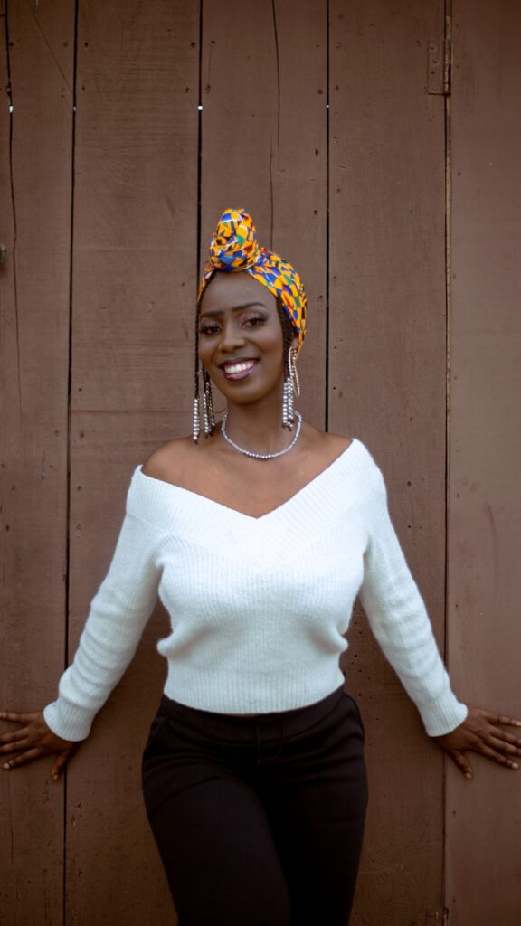 A woman standing in front of a wooden wall
